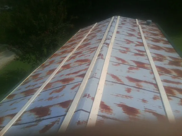 Rusted metal roof panels with new wood purlins before replacement — Storm Damage Roof Repair in Delia by Roofing Brothers